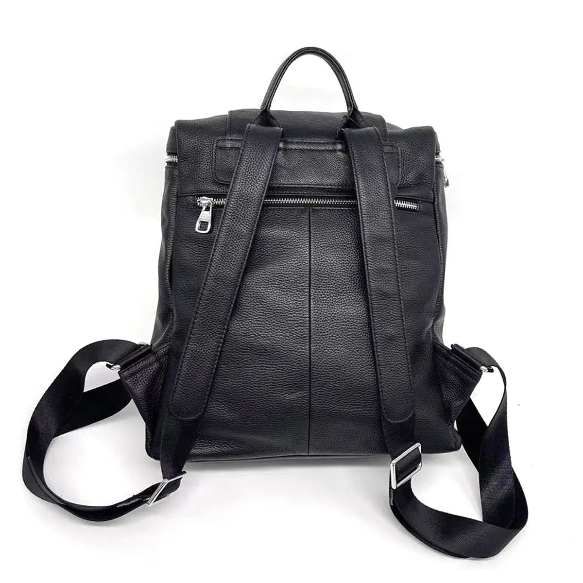 Black full-grain leather backpack, 30 x 13 x 35 cm, with curved shoulder straps and patchwork front