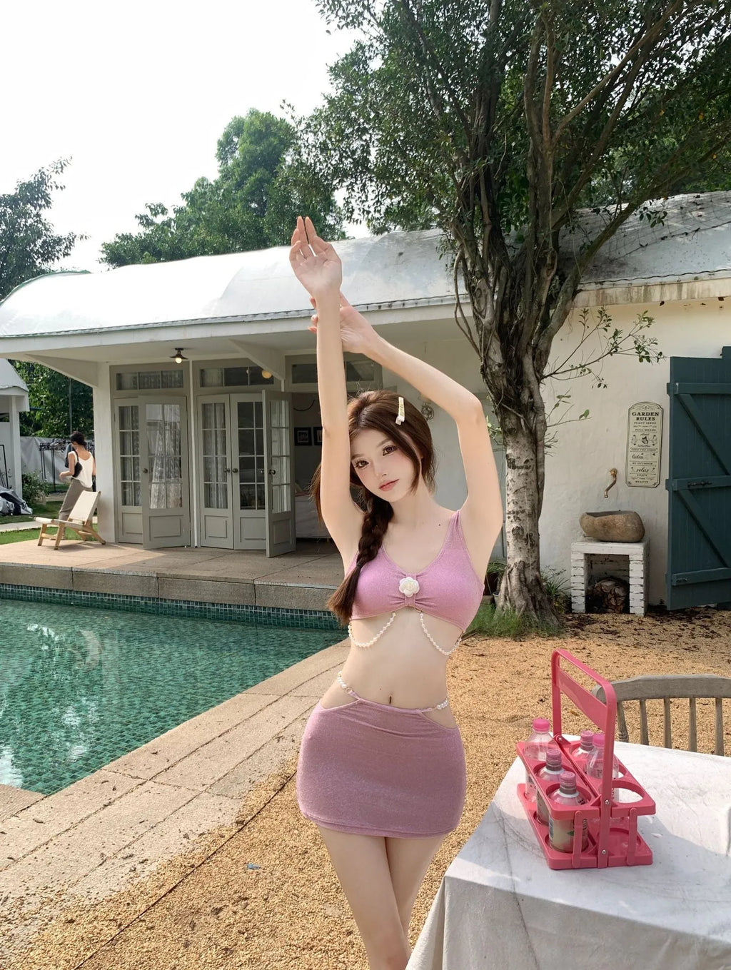 Women's pink and black three-piece polyester bikini set for swimming.