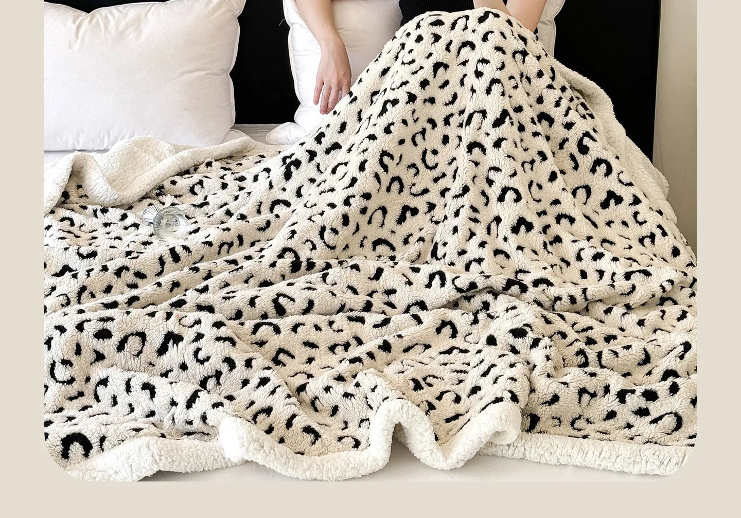 Double-layer jacquard taffeta blanket with leopard print pattern in a camel colour, laid flat on a bed.