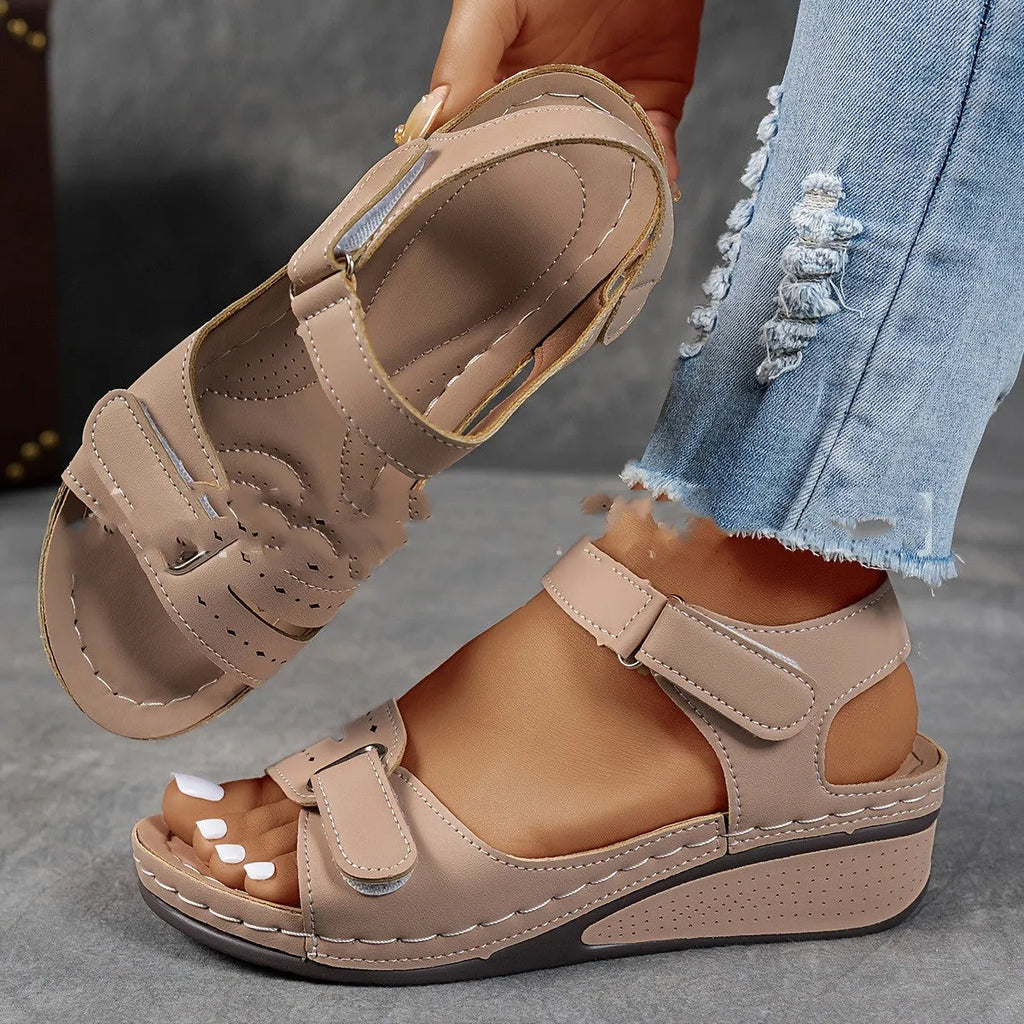 Women's beige strap sandals with a thick composite sole and adjustable Velcro fastening.