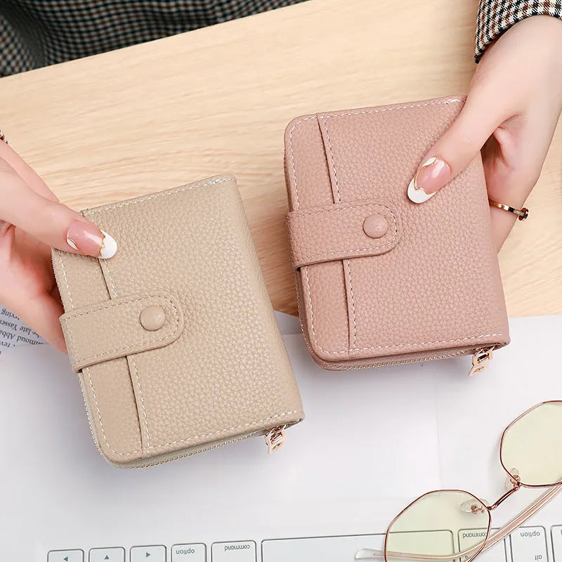 Ladies short wallet with lychee pattern in two-fold design, available in beige, pink, black, and red colours