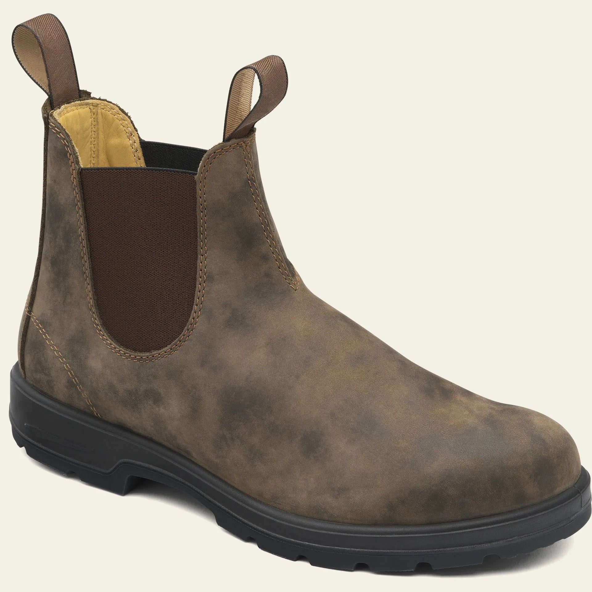 Vintage brown Chelsea boots with frosted PU upper and round toe on wooden floor