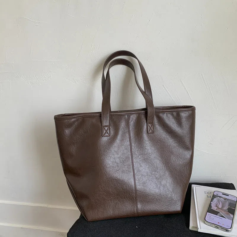 Large-capacity PU tote bag with double straps, 3D outer pocket, zip hidden pocket and phone pocket in black