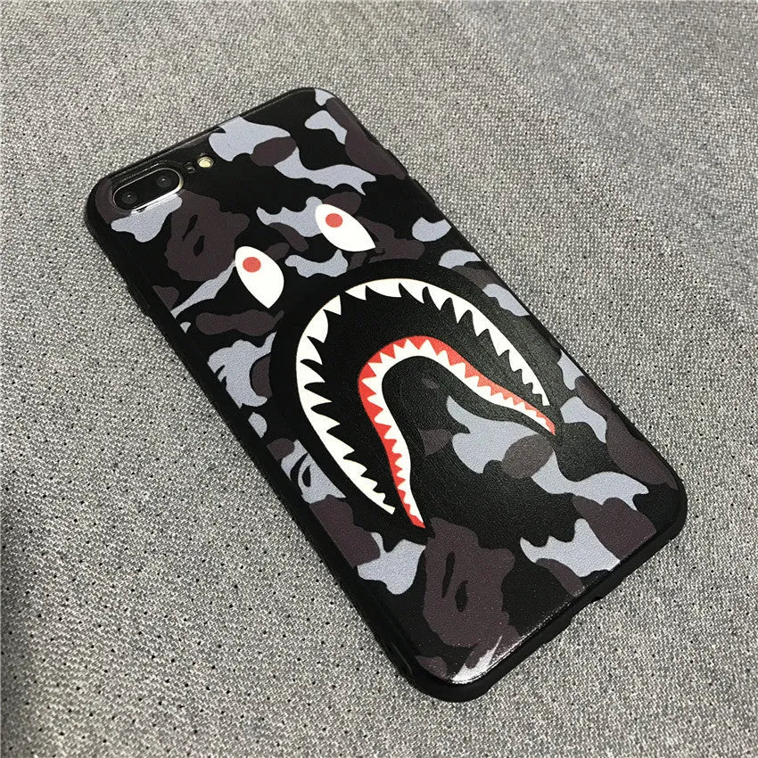 Frosted silicone phone case with shark mouth design in red, green, gray, and pink colours