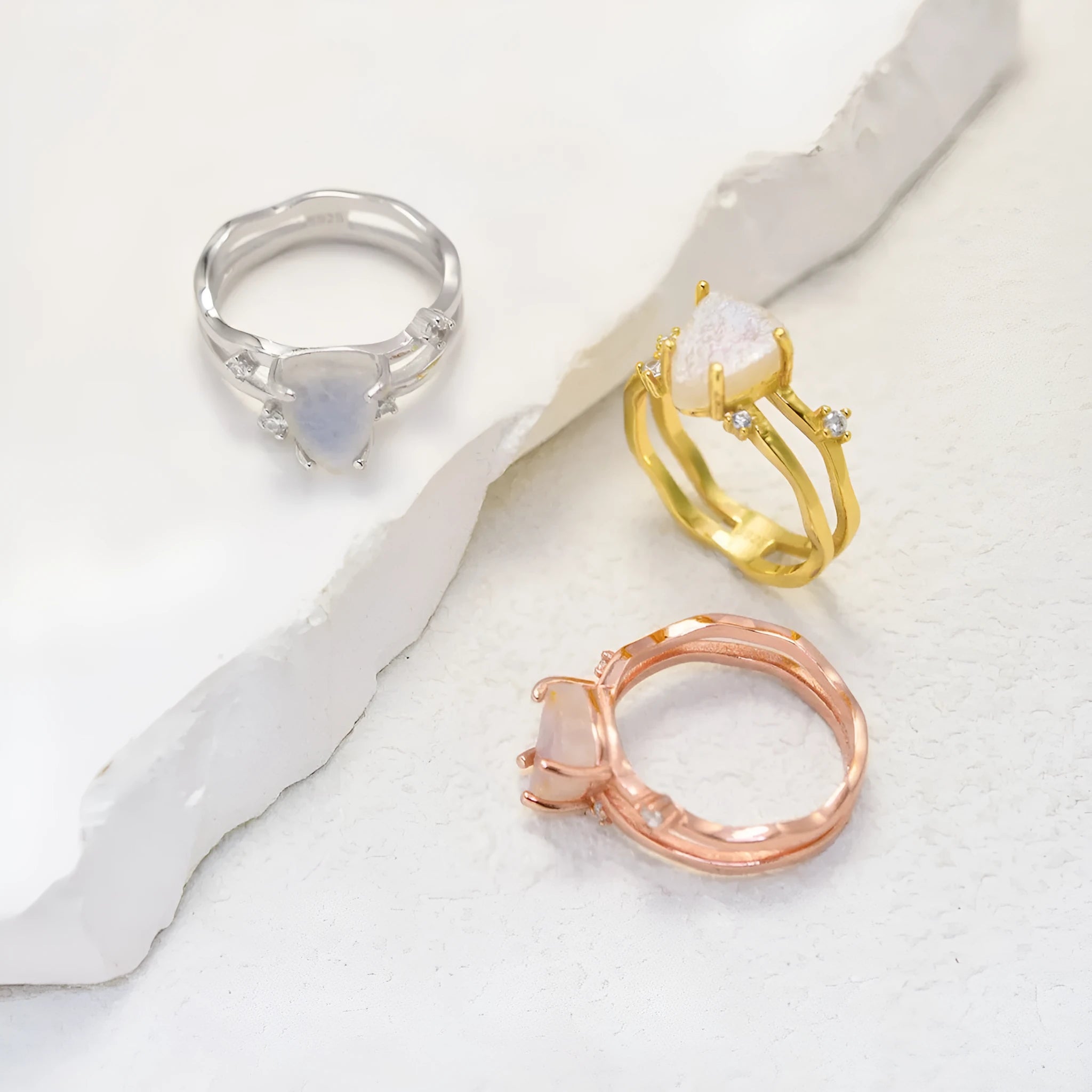 S925 silver geometric ring with triangular moonstone in rose, white, or yellow gold plating on a size guide.