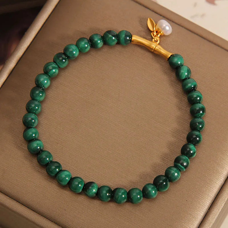 White crystal lucky bamboo bracelet with adjustable closure on a wrist.