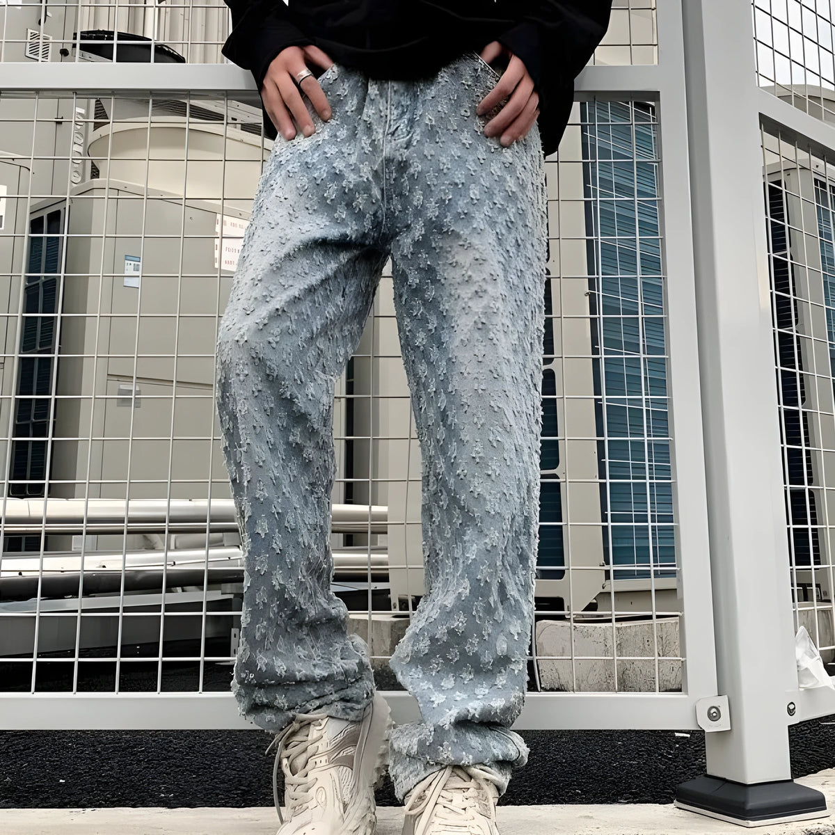 Men's black jacquard full-print denim jeans with button fly, laid flat showing all-over pattern