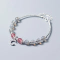 Handmade adjustable moonstone bracelet with crescent moon charm and crystal pendant on wrist