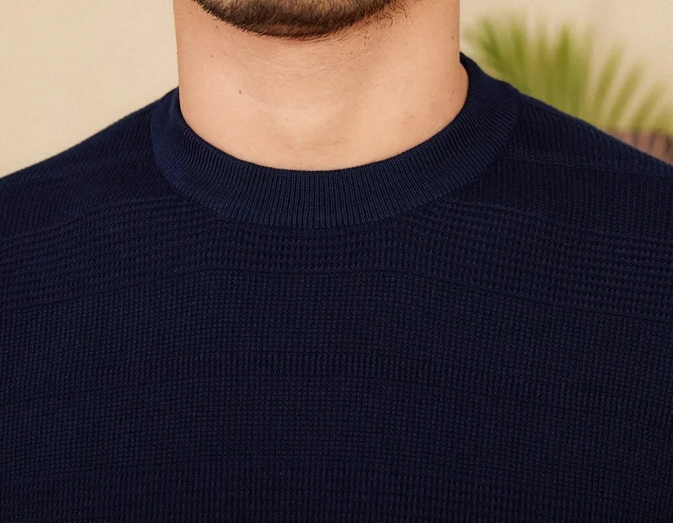Men's off-white pure cotton short sleeve T-shirt with a round neck on a hanger.