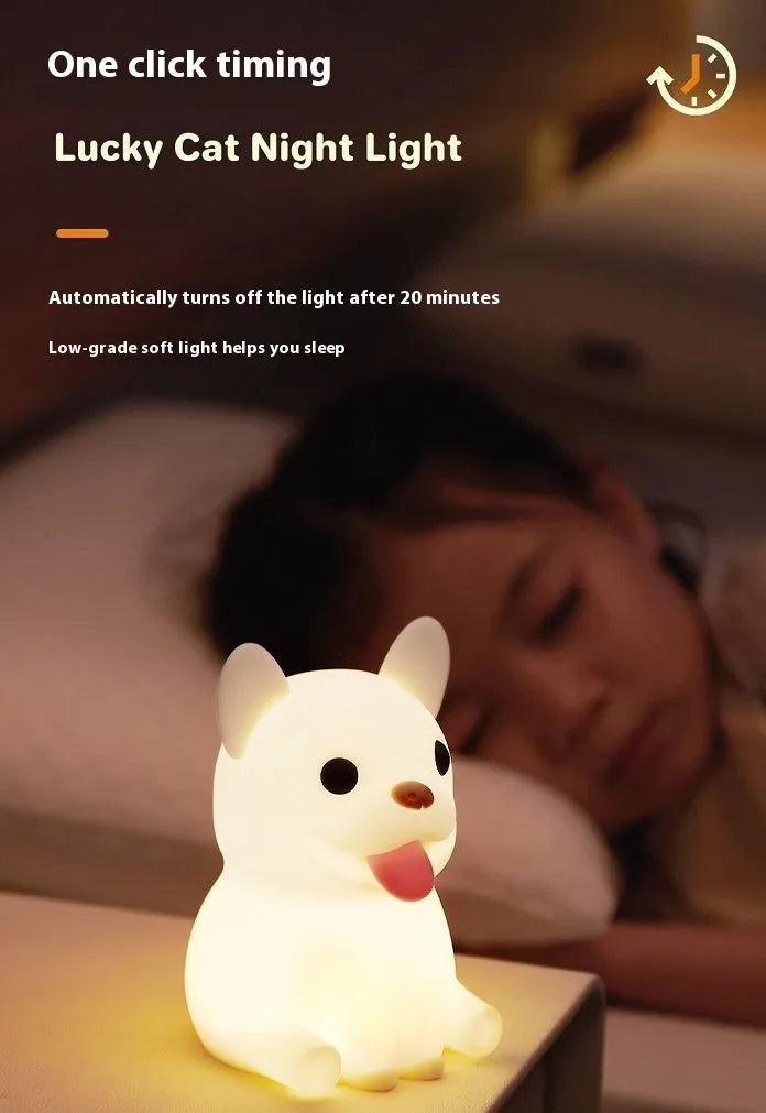 Soft silicone USB night light with dimmer in a cartoon animal design on a bedside table.
