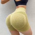 Women wearing high-waist seamless yoga shorts in black performing fitness exercises
