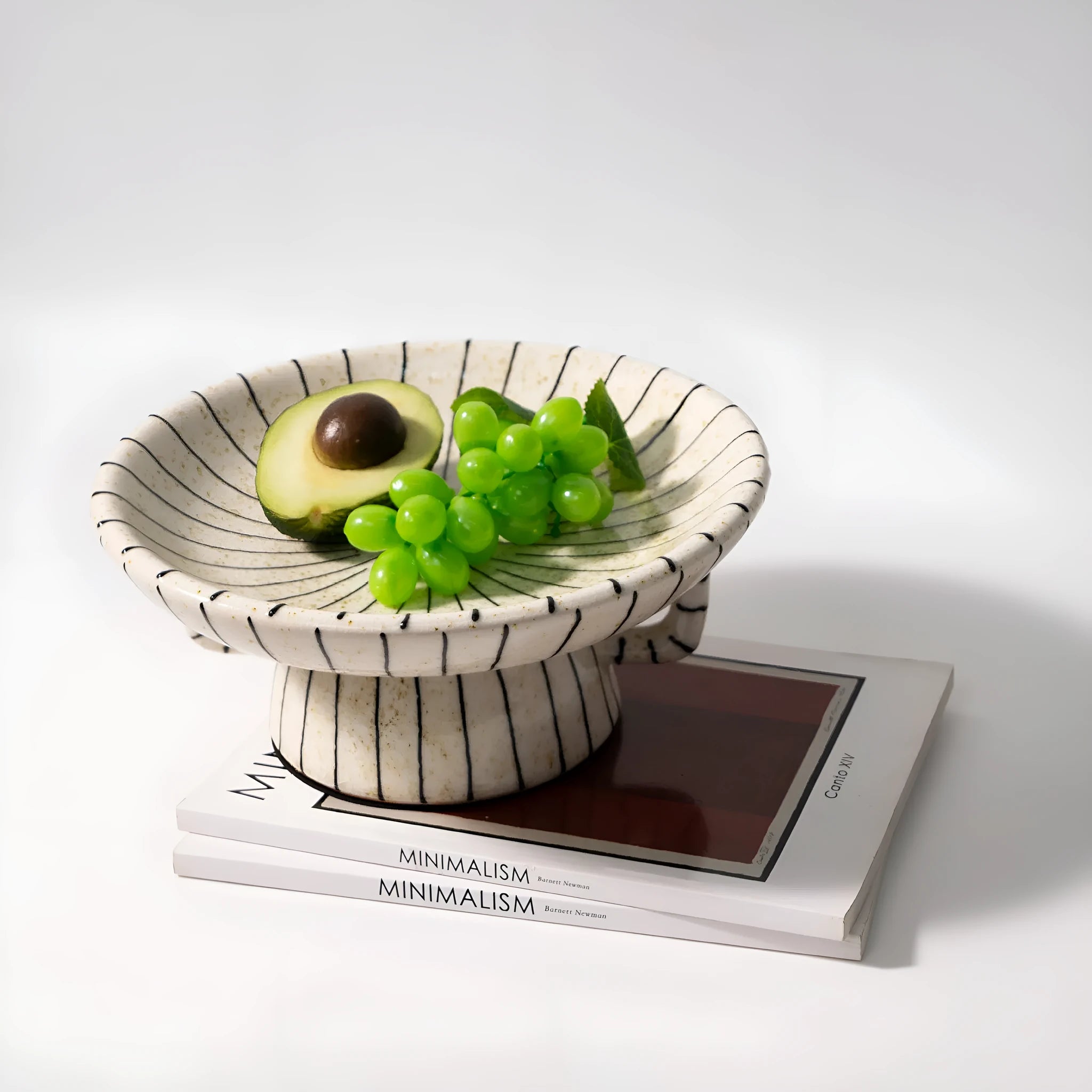 Black and white striped synthetic resin fruit plate on table