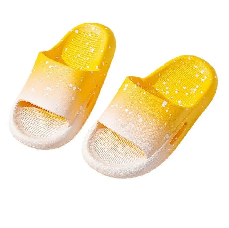 Gradient coloured PVC summer slippers for children on a plain background, showing the non-slip sole.