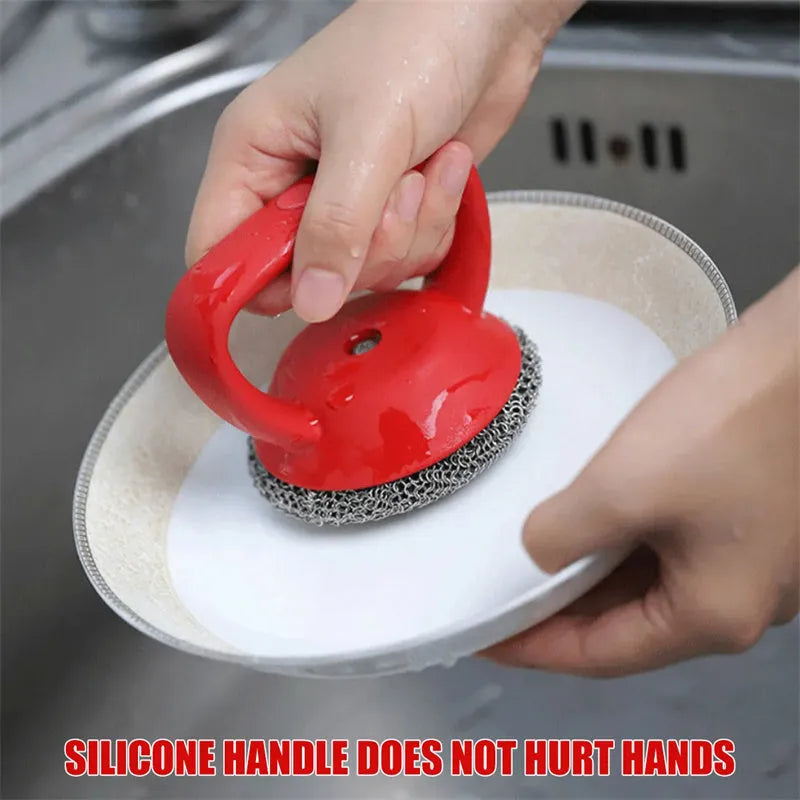 Round 316 stainless steel chainmail scrubber with red silicone handle on cast iron skillet