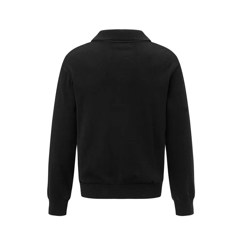 Man wearing a loose black acrylic blend pullover sweater, casual long sleeve knit top.
