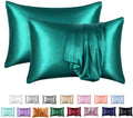 Dark blue polyester satin pillowcase with envelope closure on a bed