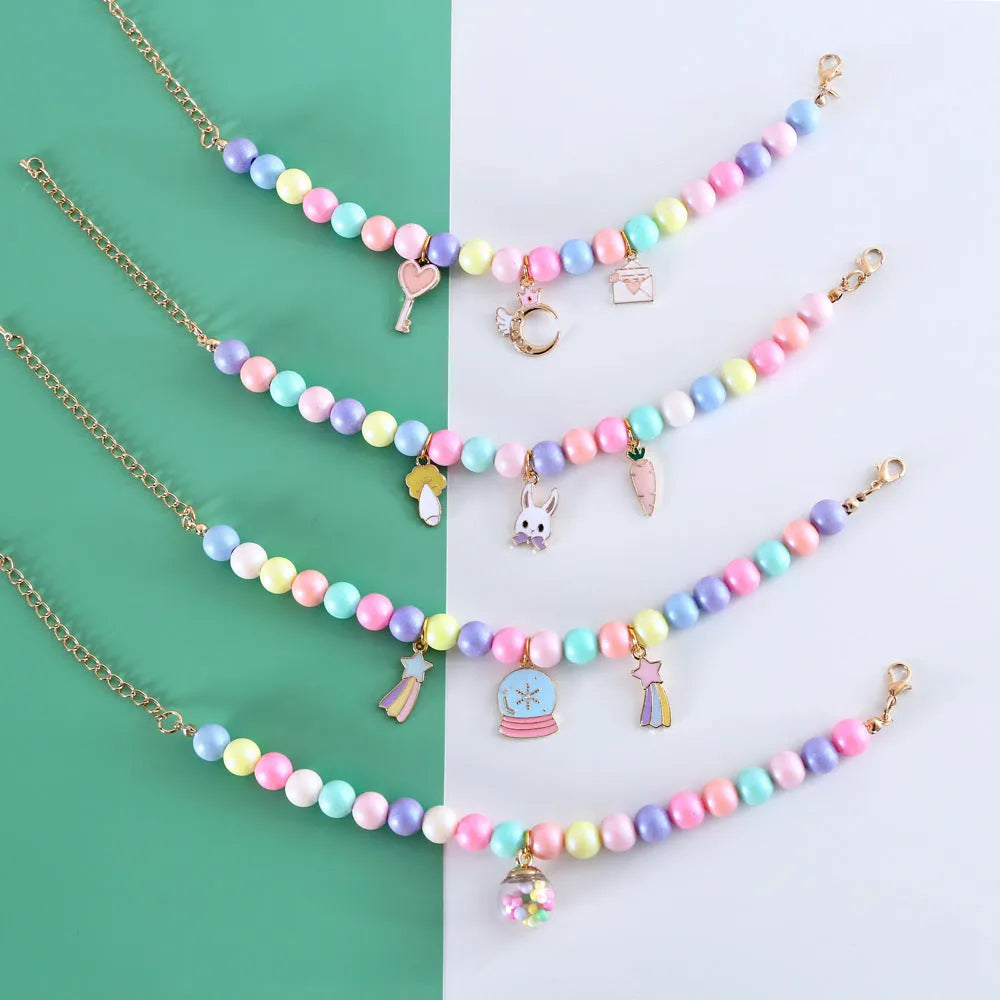 Colourful resin necklace collar and bracelet set for a dog, showing macaron-themed rabbit and moon charms.