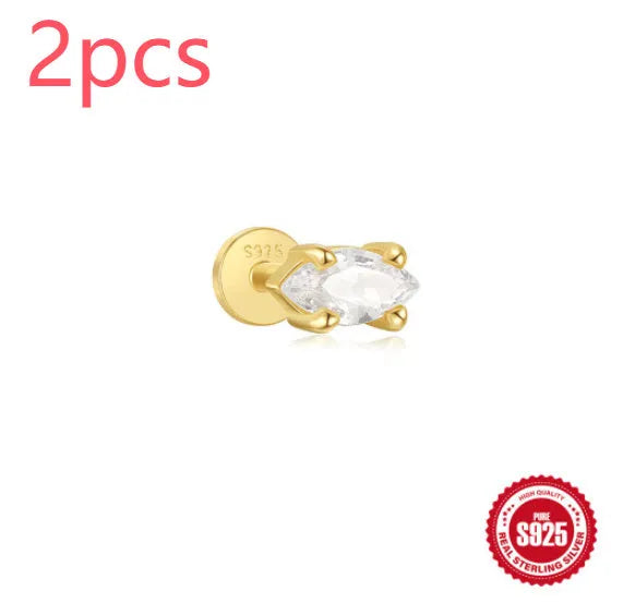 A gold tone sterling silver ear stud featuring a dangling tassel and XINGX inlaid design on the stud.