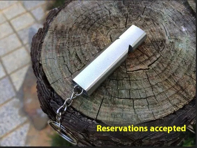 Silver and gold aluminium alloy double hole outdoor survival whistle.