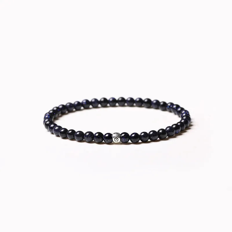 Fine geometric bracelet with black obsidian, blue san, and black agate 4mm beads on an adjustable band.