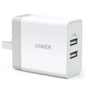 White dual-port 12W USB charger with national standard plug on a plain background