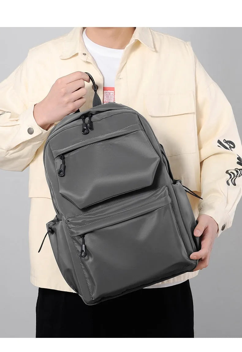 Blue Oxford cloth student backpack with anti-theft design and USB charging port, side view