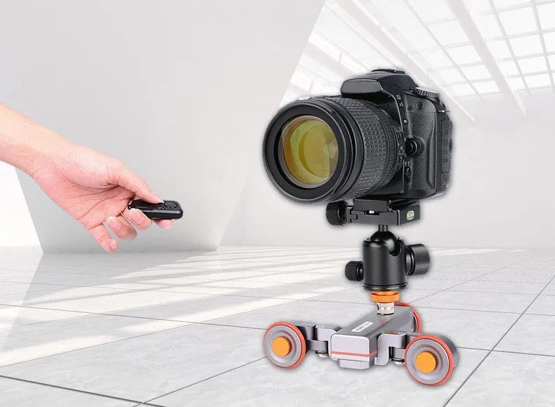 Wolf King L4X mobile camera remote control slide car with black body and silver remote on a tabletop
