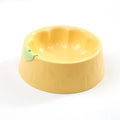 Green plastic double pet bowl for dog and cat food and water on a white background