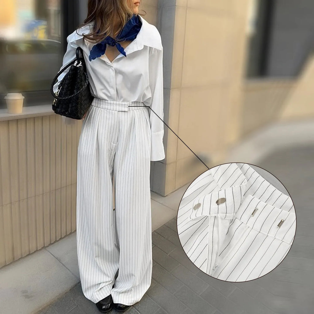 White striped wide-leg casual trousers with zipper detailing on a mannequin.
