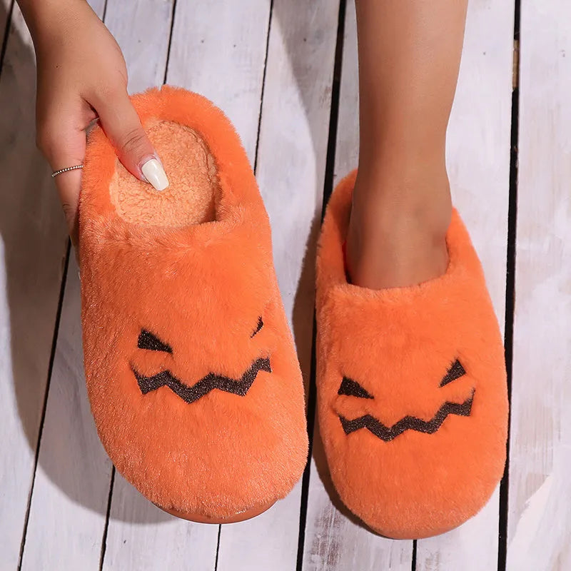 Orange plush Halloween pumpkin slippers with coral velvet upper and flat PVC sole.