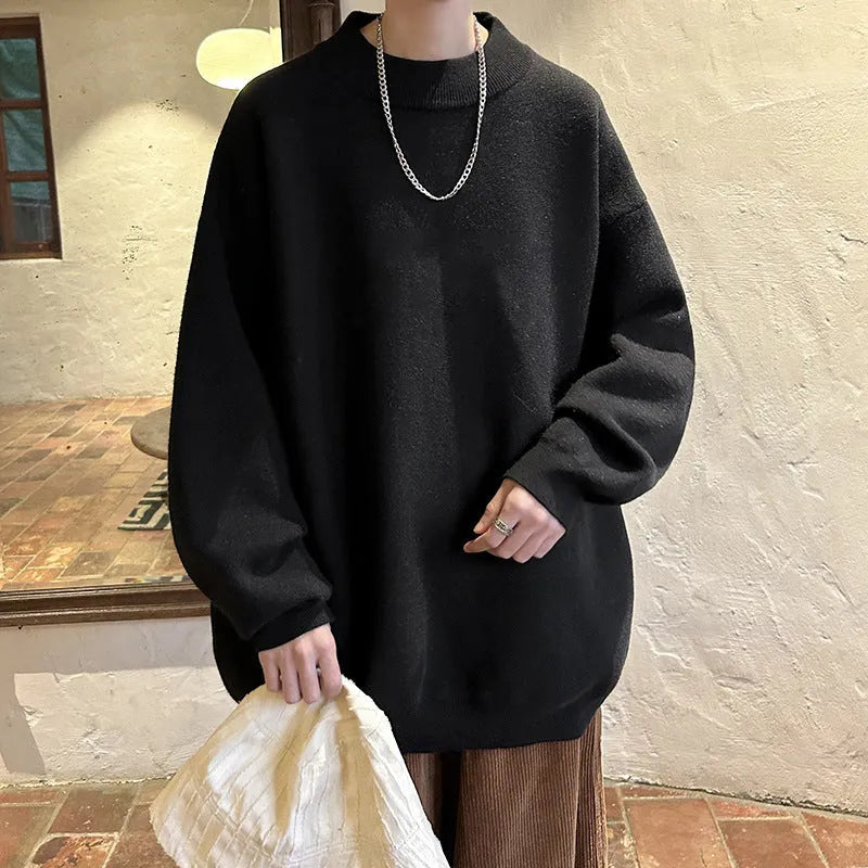 A man's solid colour round neck pullover sweater with long sleeves in a loose, casual fit.