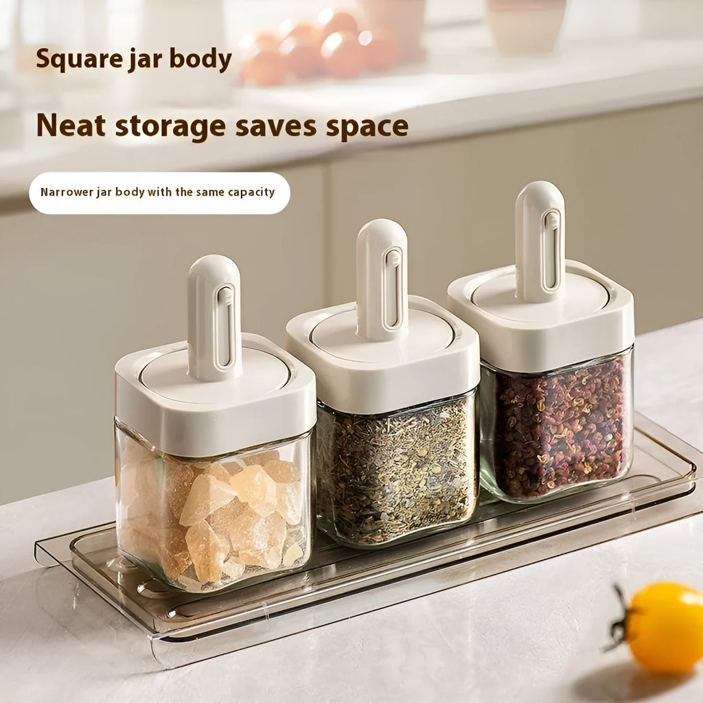 Retractable glass seasoning jar in Nordic style with green lid, showing clear glass body and dispensing mechanism