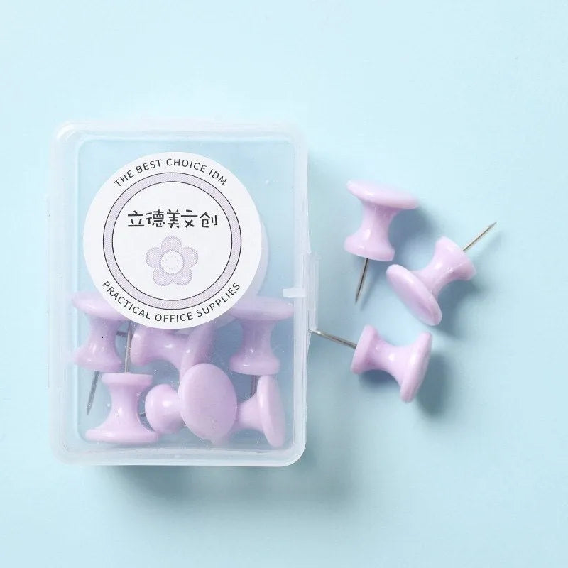 Plastic push pins in cherry blossom pink, mint green, and lavender colours, shown in large and small sizes, packaged in a box.