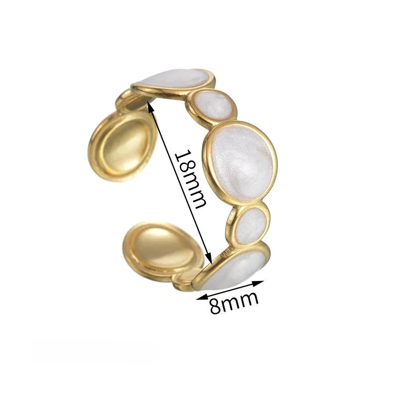 A stainless steel geometric ring with an adjustable opening on a plain background.