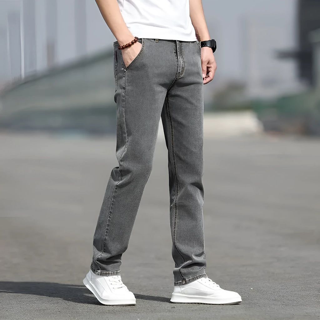 Men's straight-leg jeans in smoky grey colour with low waist design and zipper fly closure