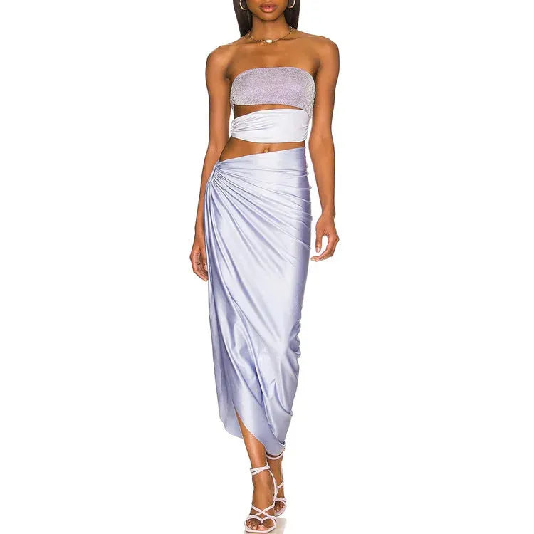 Purple women's one-piece swimsuit with hollow design and matching wrap skirt on mannequin