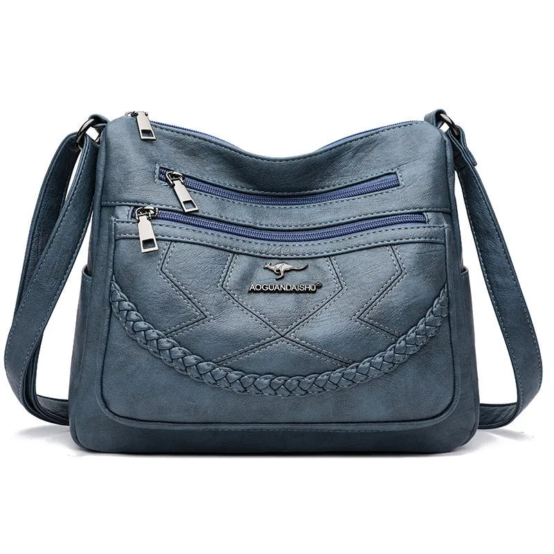 Soft PU leather women's shoulder bag in black colour showing crossbody strap and exterior pockets