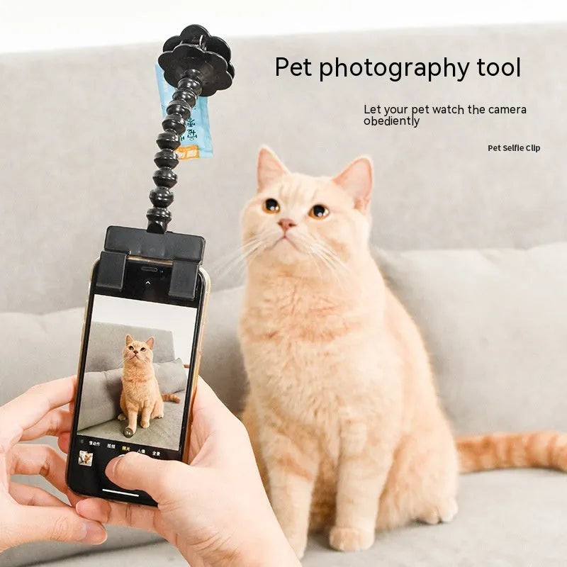 Black pet selfie stick with rotating snack clip attached to mobile phone for animal photography