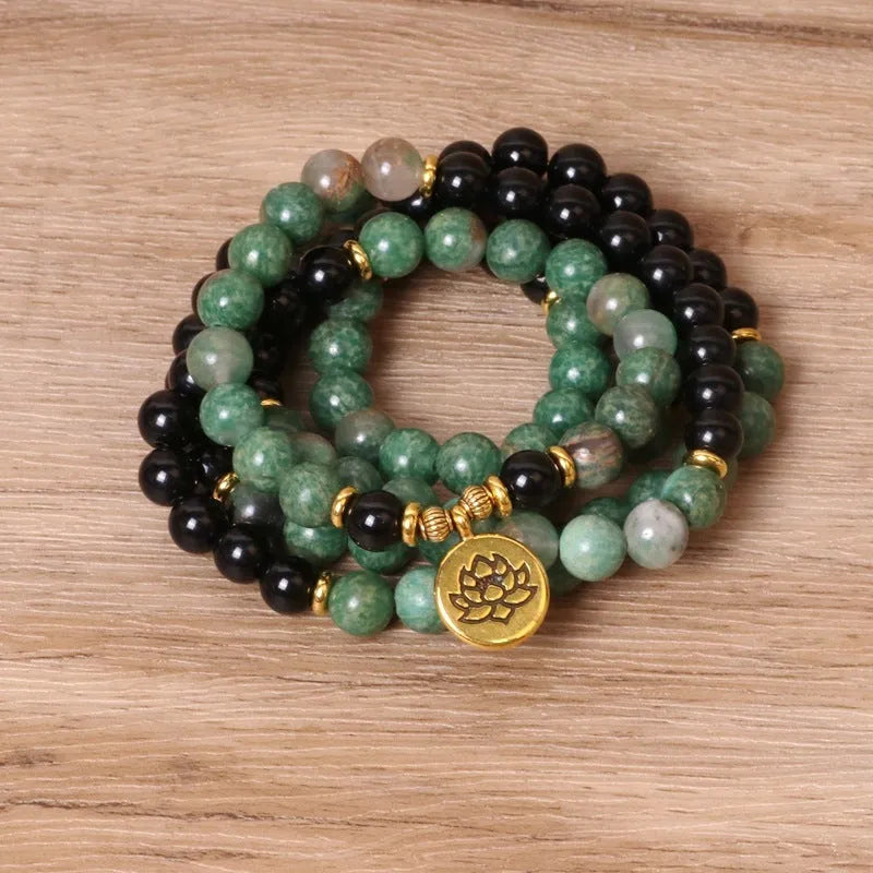 Green and black elastic beaded alloy bracelet showing stretch design and natural style