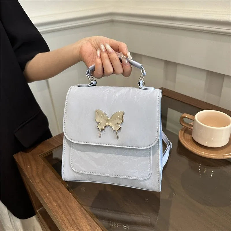 Women's preppy style PU backpack with hand-carry handle showing bow decoration and six colour options