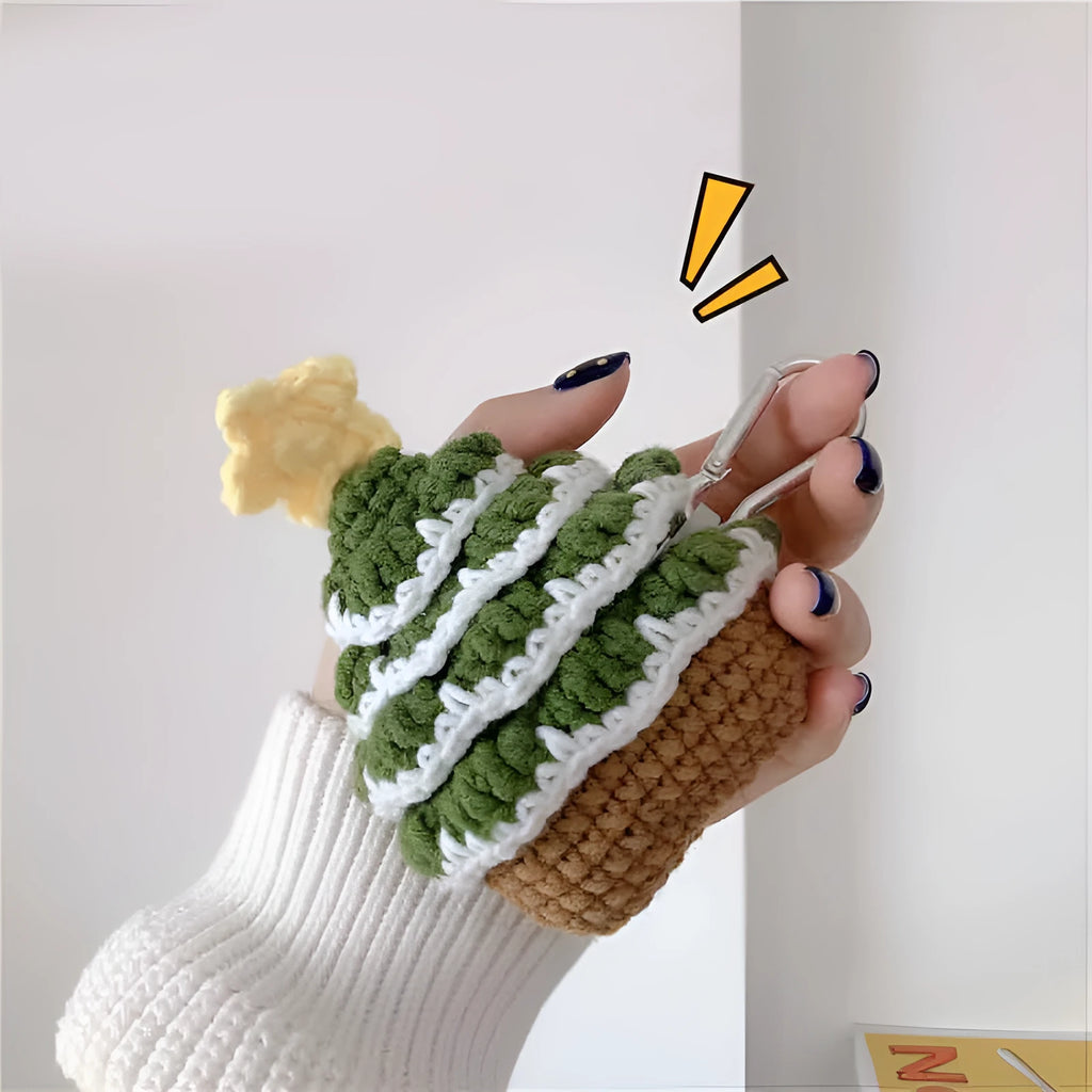 Green knitted Christmas tree flip-style headset case for AirPods with silver hook on white background
