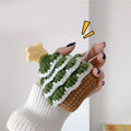 Green knitted Christmas tree flip-style headset case for AirPods with silver hook on white background