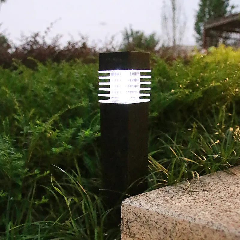 White cuboid solar-powered ground stake light for garden pathways