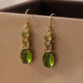 A pair of green copper geometric earrings with a quadrilateral shape and retro bohemian style.
