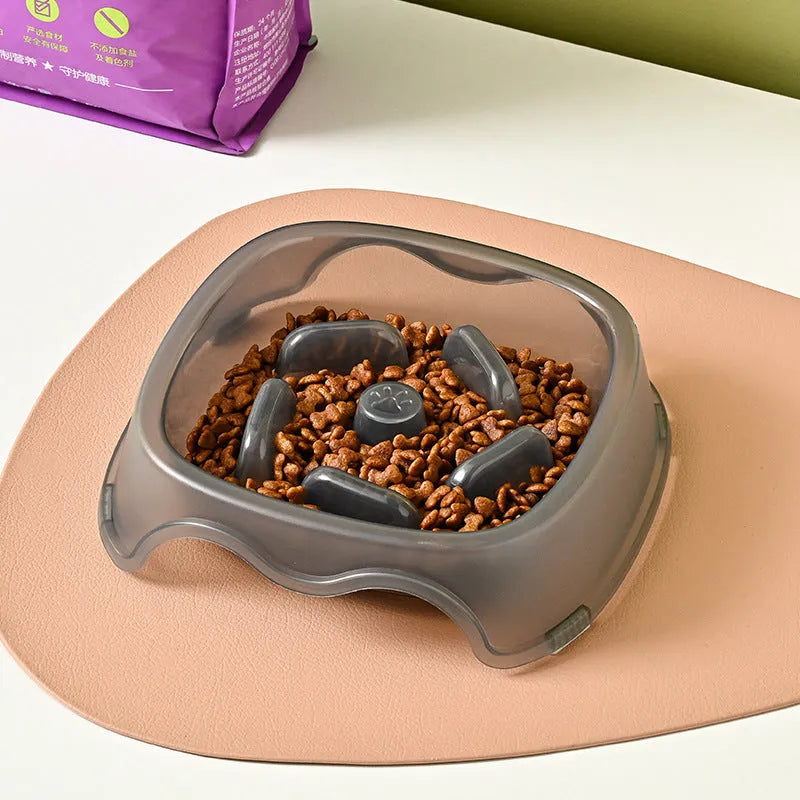 Blue plastic dog slow feeder bowl on a floor, designed to prevent choking by slowing eating pace.