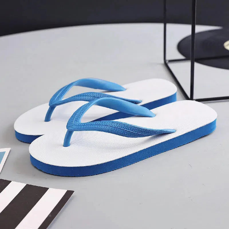 Rubber beach flip-flops with fish label in green, red, blue, or black, showing non-slip patterned sole.