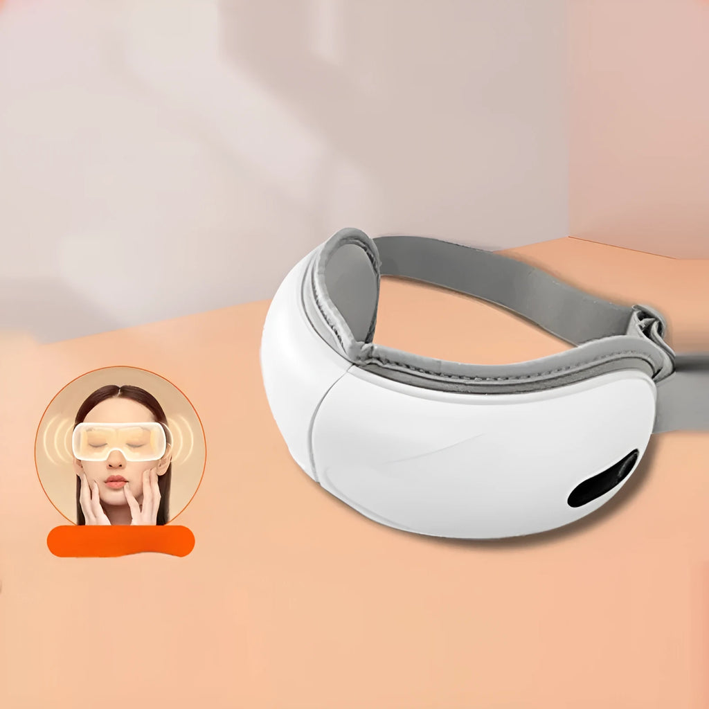 White rechargeable eye massager with airbag massage and hot compress functions on a table