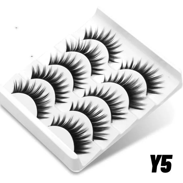 Box of artificial fibre false eyelashes and adhesive glue for a natural long, thick lash look.