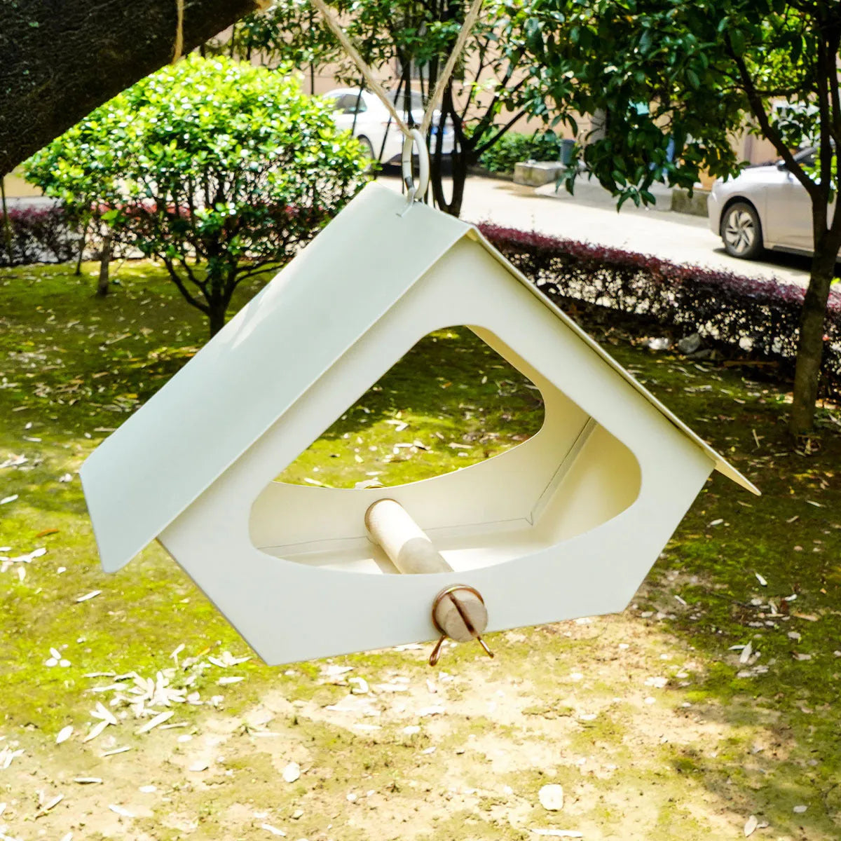 Modern simple iron bird house with anti-rain roof in garden setting