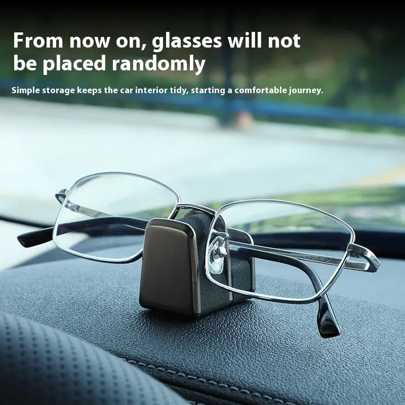 Zinc alloy and leather car dashboard clip for holding sunglasses, shown in green.